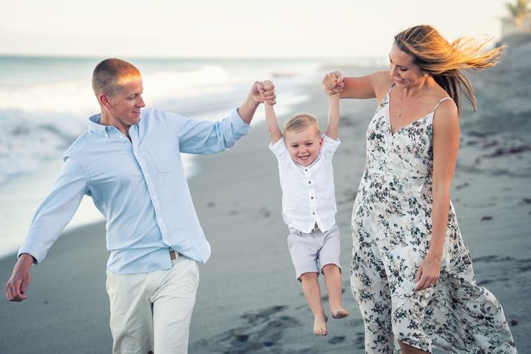 Family holding hands on the beach