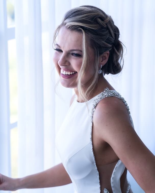 Bride laughing by the window